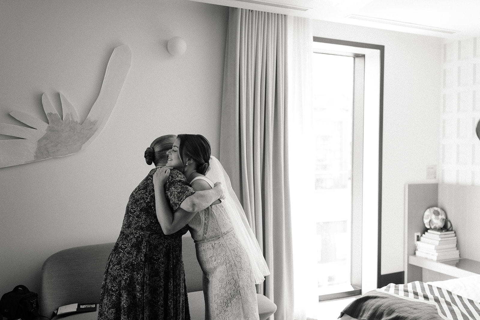 bride hugging mom in her suite at the drake hotel